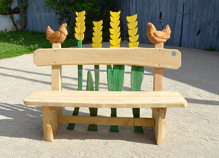 rustic bench with backrest and elements in "wheat ears" design, end posts in "chicken" design